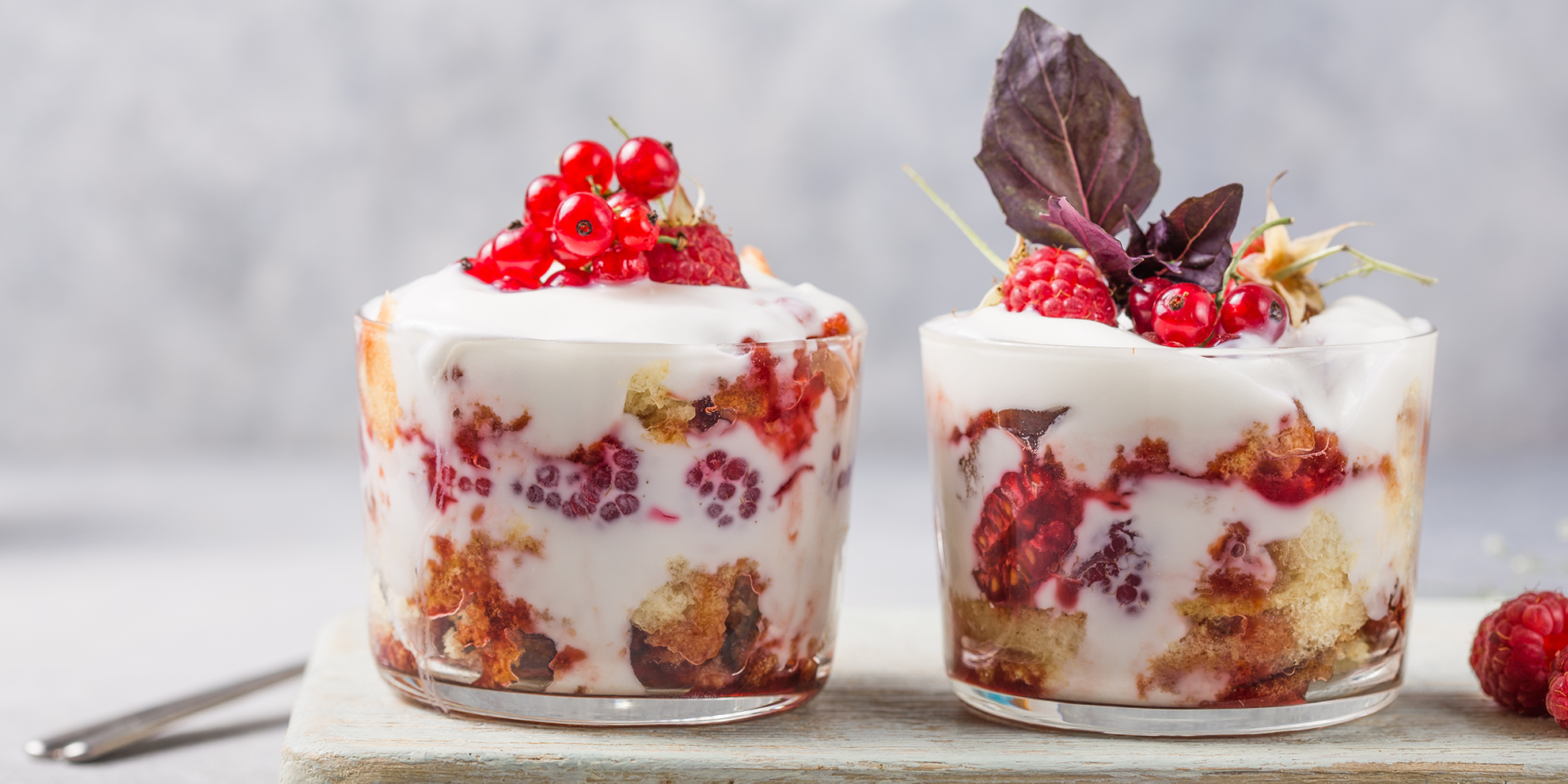 Trifle with sponge cake, whipped cream, and raspberries
